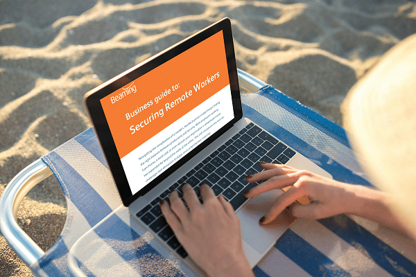 Securing remote workers PDF guide being read on a laptop on the beach